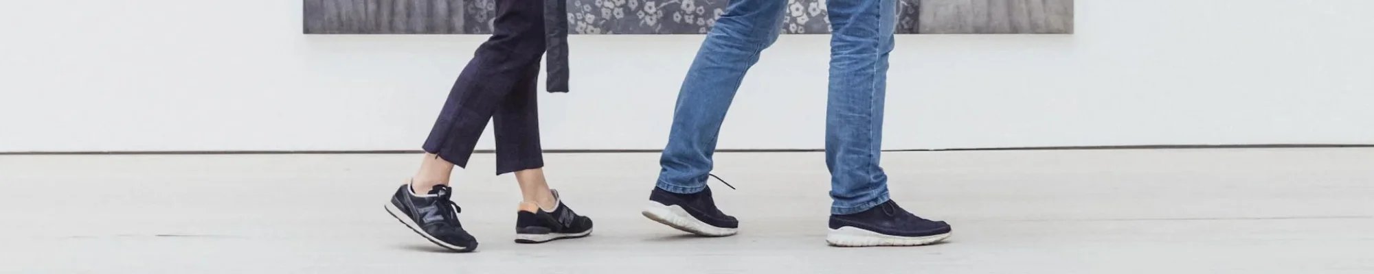 Customers walking in a bright commercial space with light flooring