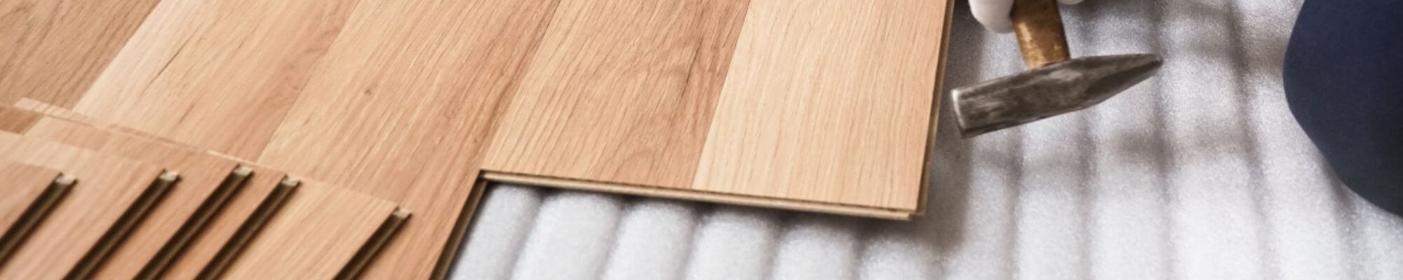 Flooring contractor installing wood flooring