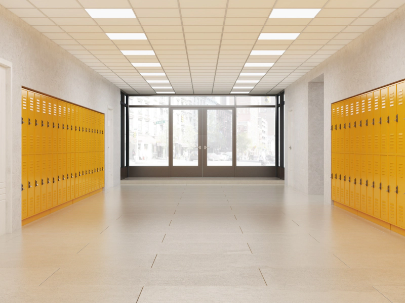 Commercial flooring in a bright school hallway with yellow lockers